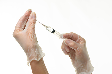 Image showing Doctor\'s hands take medicine with a syringe from an ampoule