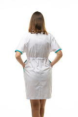 Image showing Girl in a white medical coat, view from the back, isolated on a white background