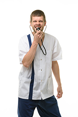 Image showing Irritated doctor yelling into phonendoscope head and looking into frame isolated on white