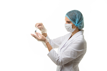 Image showing Doctor picks up medicine with syringe from ampoule, isolated on white background