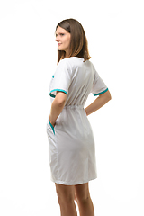 Image showing Side view of girl in white medical coat, isolated on white background