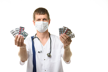 Image showing Doctor stretches out his hands with medications into the frame