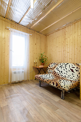 Image showing Country house room interior, sofa, small table and white tulle curtained window