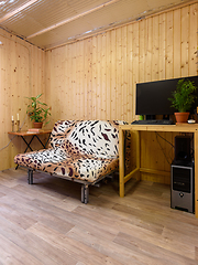 Image showing Interior of a country house room, next to the sofa is a computer desk