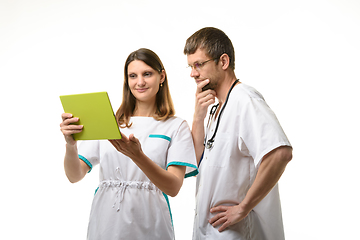 Image showing The nurse shows the test results in a tablet computer, the doctor looks thoughtfully at the screen