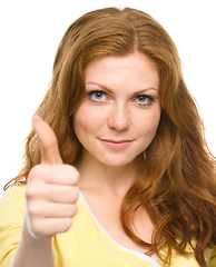 Image showing Woman is showing thumb up gesture