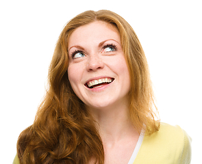 Image showing Young happy woman is looking up and smile