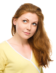 Image showing Young happy woman is looking up and smile