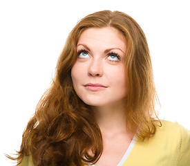 Image showing Young happy woman is looking up and smile