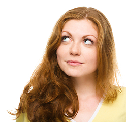 Image showing Young happy woman is looking up and smile