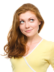 Image showing Young happy woman is looking up and smile