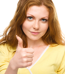 Image showing Woman is showing thumb up gesture