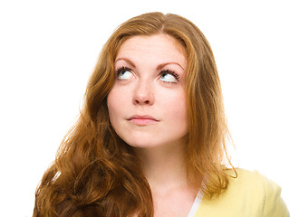 Image showing Young happy woman is looking up and smile