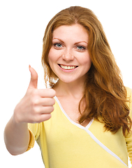 Image showing Woman is showing thumb up gesture