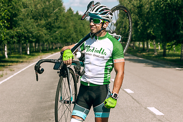 Image showing Dnipro, Ukraine - July 12, 2019: athlete with disabilities or amputee training in cycling