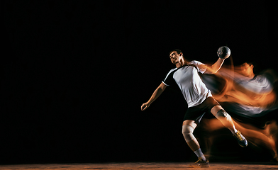 Image showing Young handball player against dark studio background in mixed light