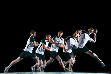 Image showing Young handball player against dark studio background in strobe light