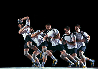 Image showing Young handball player against dark studio background in strobe light