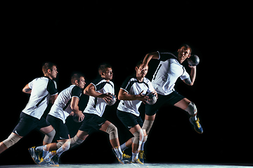 Image showing Young handball player against dark studio background in strobe light