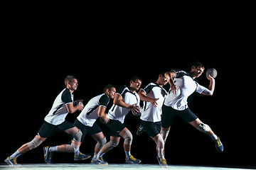 Image showing Young handball player against dark studio background in strobe light