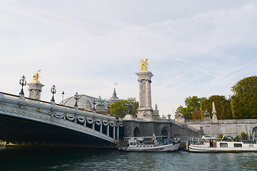 Image showing Boats moored at the foot of the Pont d\'Alexandre III on the Rive