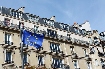 Image showing EU flag flies against a backdrop of housing in Paris