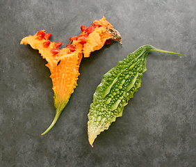 Image showing Split orange bitter gourd and a green bitter melon