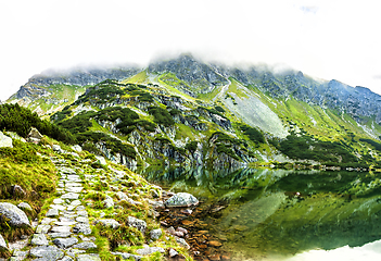 Image showing Tourist hiking trail along the picturesque mountain lake