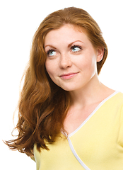 Image showing Young happy woman is looking up and smile