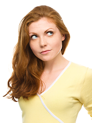 Image showing Young happy woman is looking up and smile