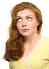 Image showing Young happy woman is looking up and smile