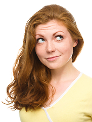 Image showing Young happy woman is looking up and smile