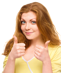 Image showing Woman is showing thumb up gesture