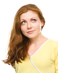 Image showing Young happy woman is looking up and smile