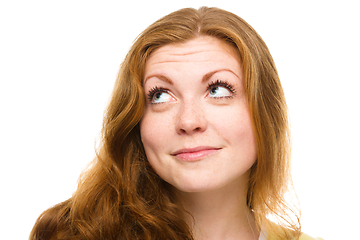 Image showing Young happy woman is looking up and smile