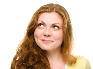 Image showing Young happy woman is looking up and smile