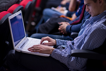 Image showing businessman using laptop computer during seminar