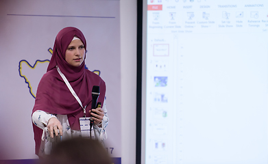 Image showing Muslim businesswoman giving presentations