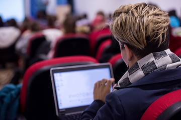 Image showing businesswoman using laptop computer during seminar