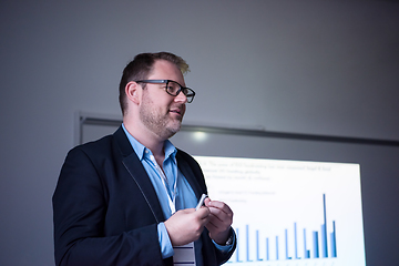 Image showing successful businessman giving presentations at conference room