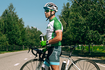 Image showing Dnipro, Ukraine - July 12, 2019: athlete with disabilities or amputee training in cycling