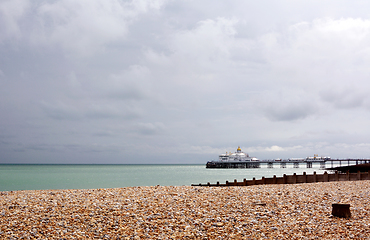 Image showing View across pebble beach to Eastbourne pier on the English coast