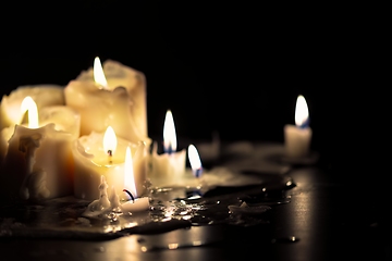 Image showing Candles glowing against dark background