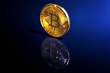 Image showing Physical shiny bitcoin agains dark background