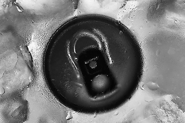 Image showing Aluminium tin can in fridge with ice closeup photo