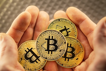 Image showing Physical bitcoin held in hands closeup