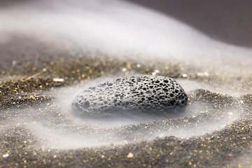 Image showing Smoke whirling around small meteorite stone