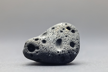 Image showing Smoke whirling around small meteorite stone