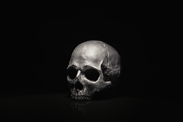 Image showing Spooky dark black skull aginast dark background