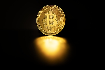 Image showing Physical shiny bitcoin agains dark background